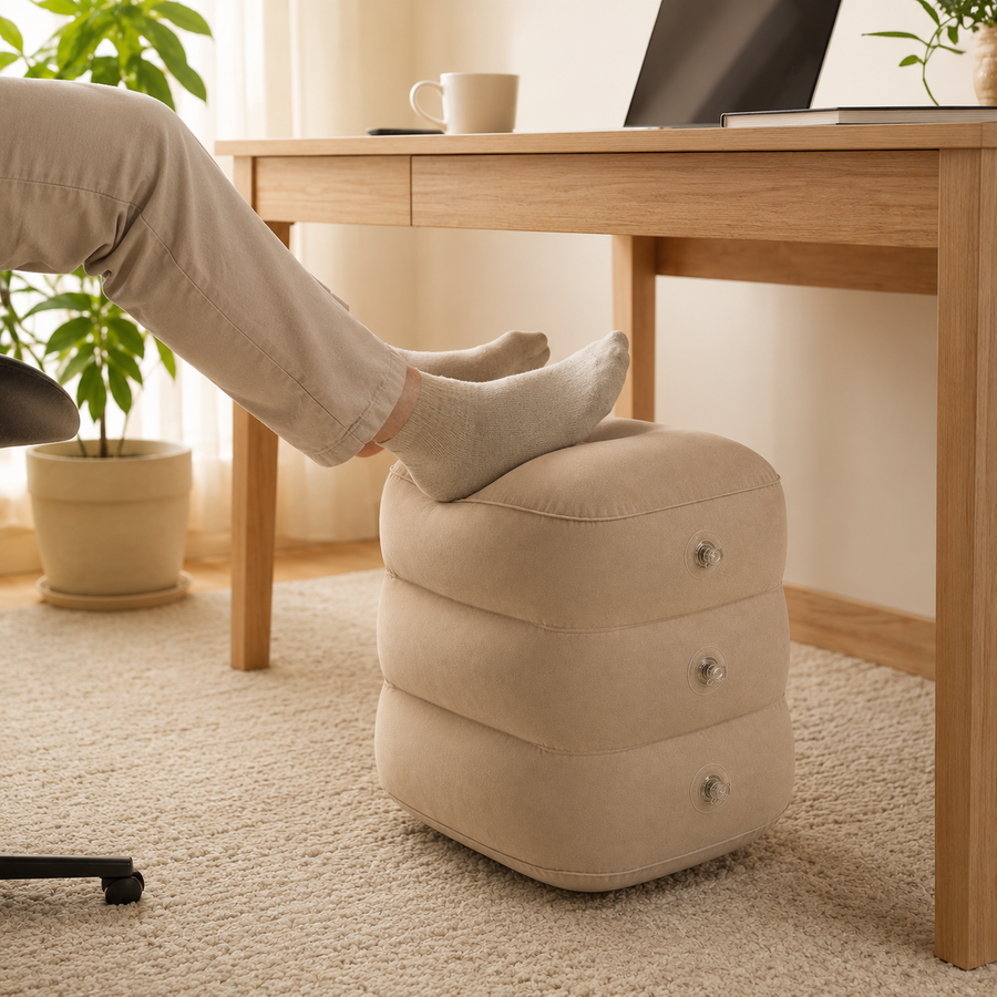 Person resting feet on the Lumora inflatable footrest under a desk